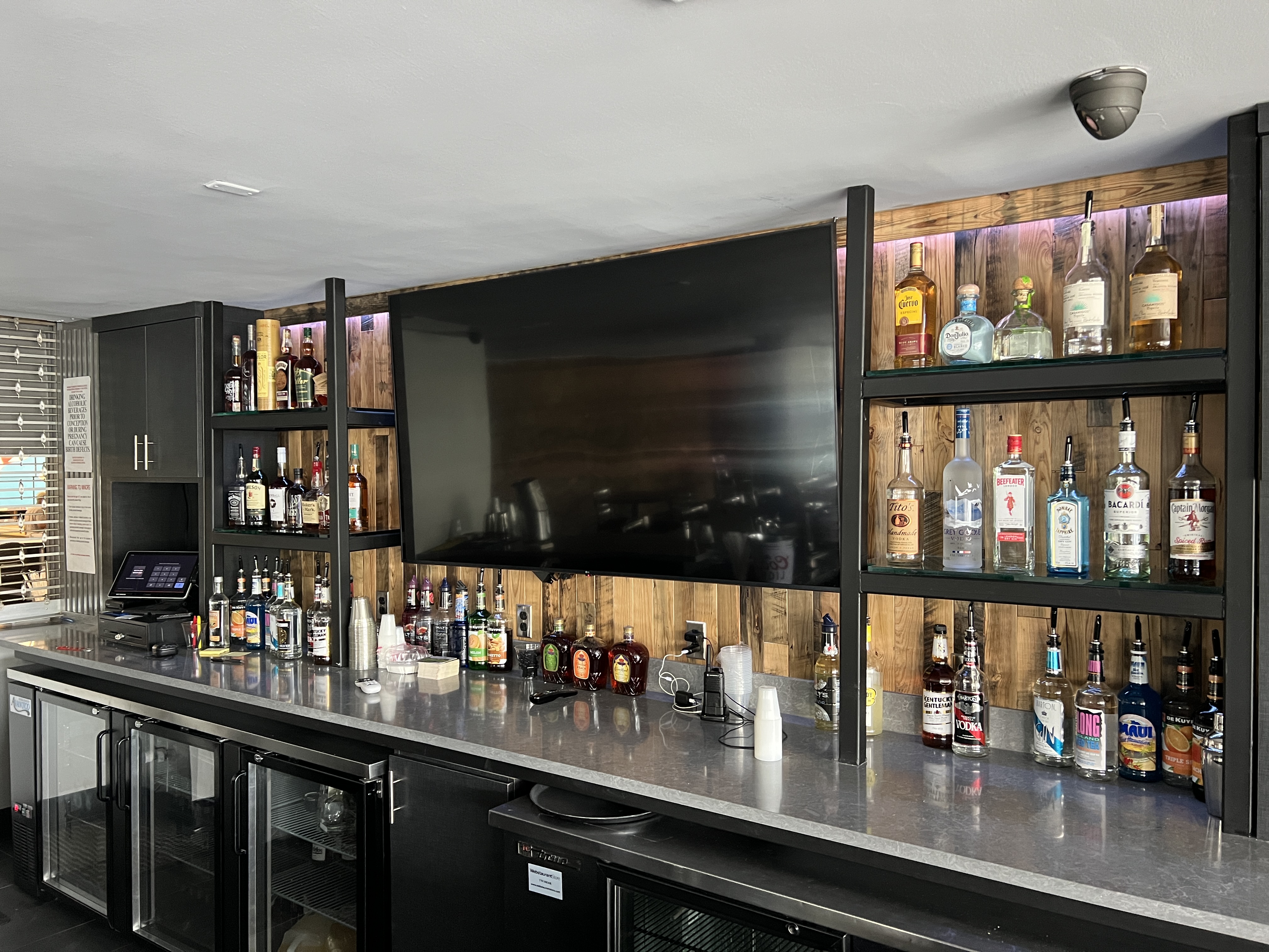 11th Frame Lounge bar with a large television and bourbon selection