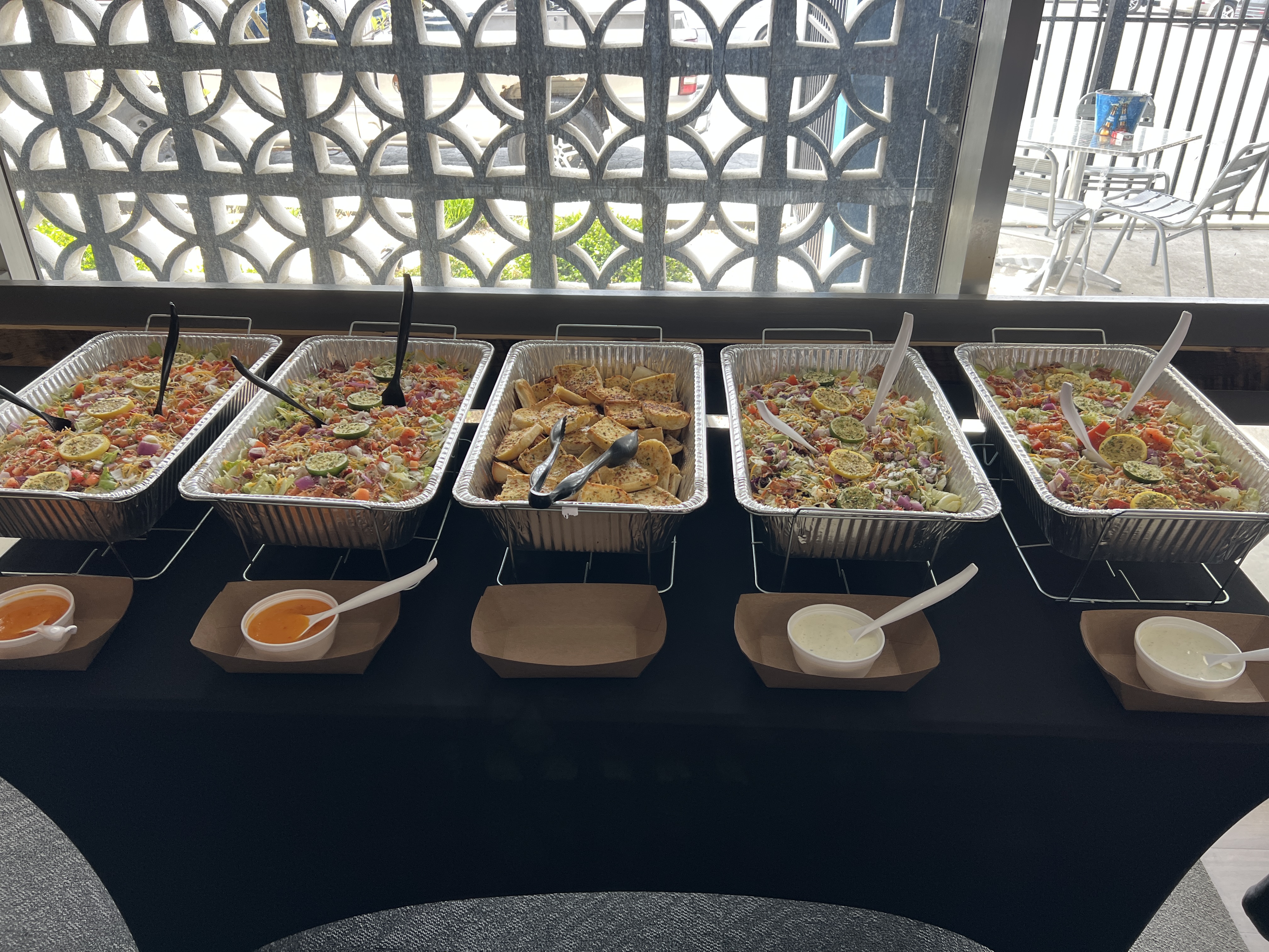 Catered buffet with salads and garlic bread