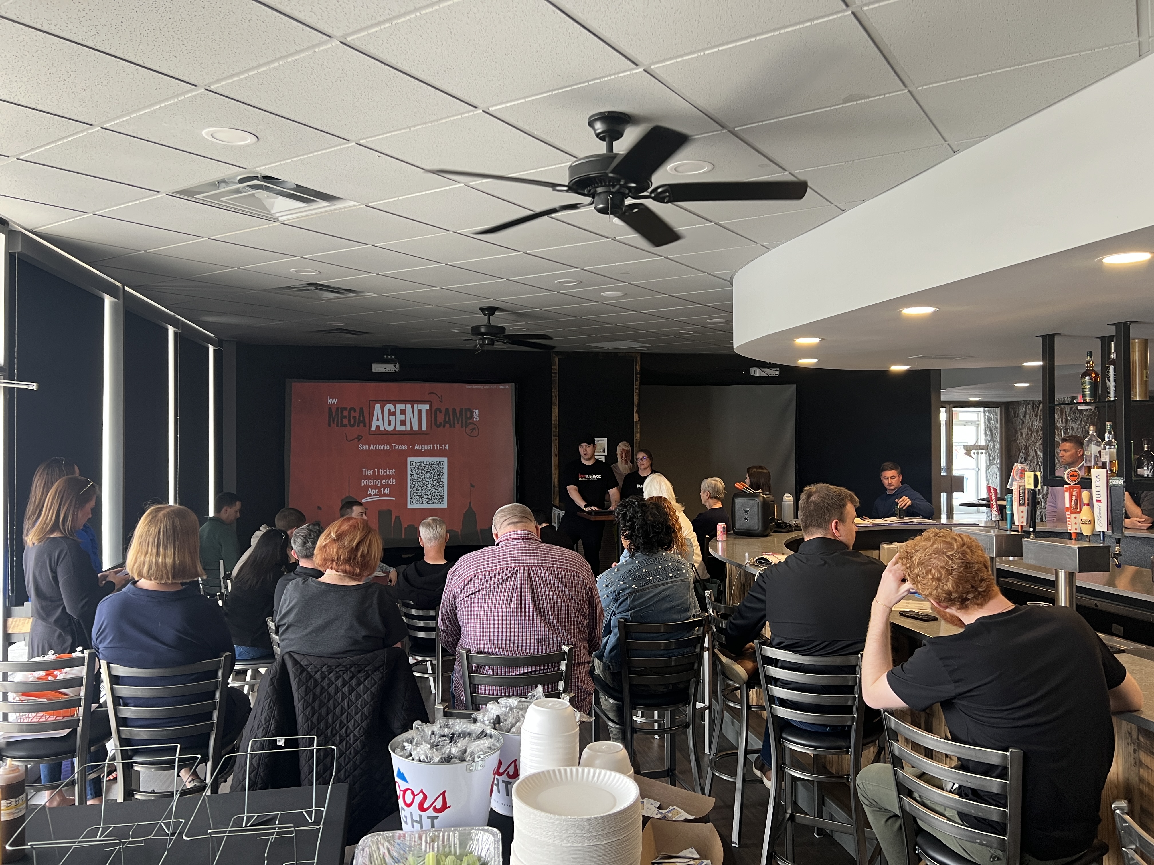 Company presentation displayed on a large screen inside the 11th Frame Lounge