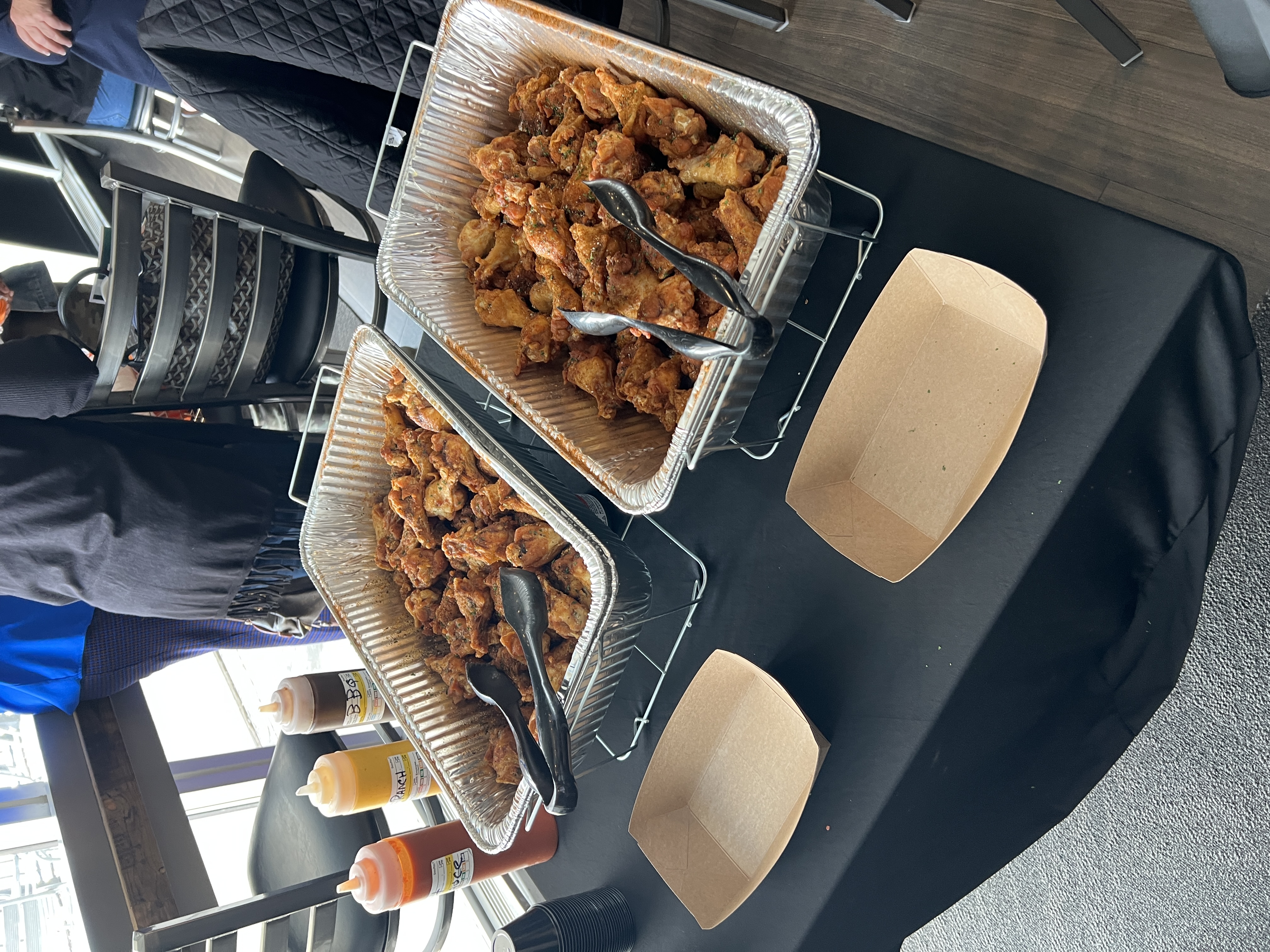 Trays of catered wings with assorted sauces