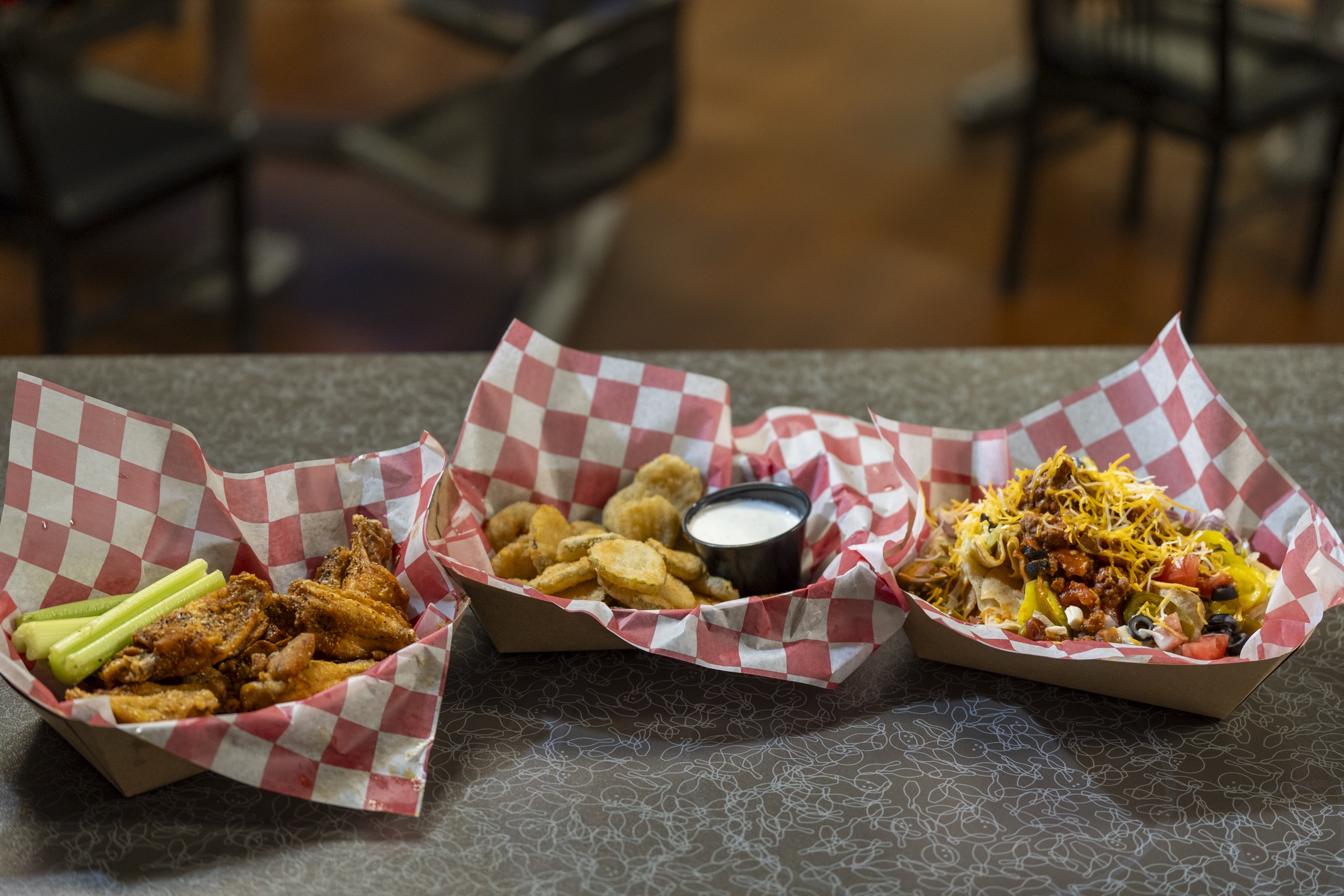 Wings, fried pickles, nachos, and other group food selections from the 300 Grill