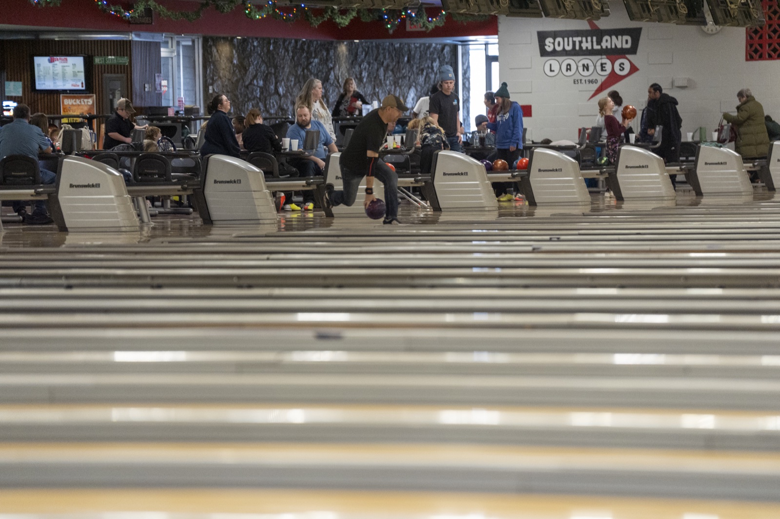 An active league night with multiple bowlers at Southland