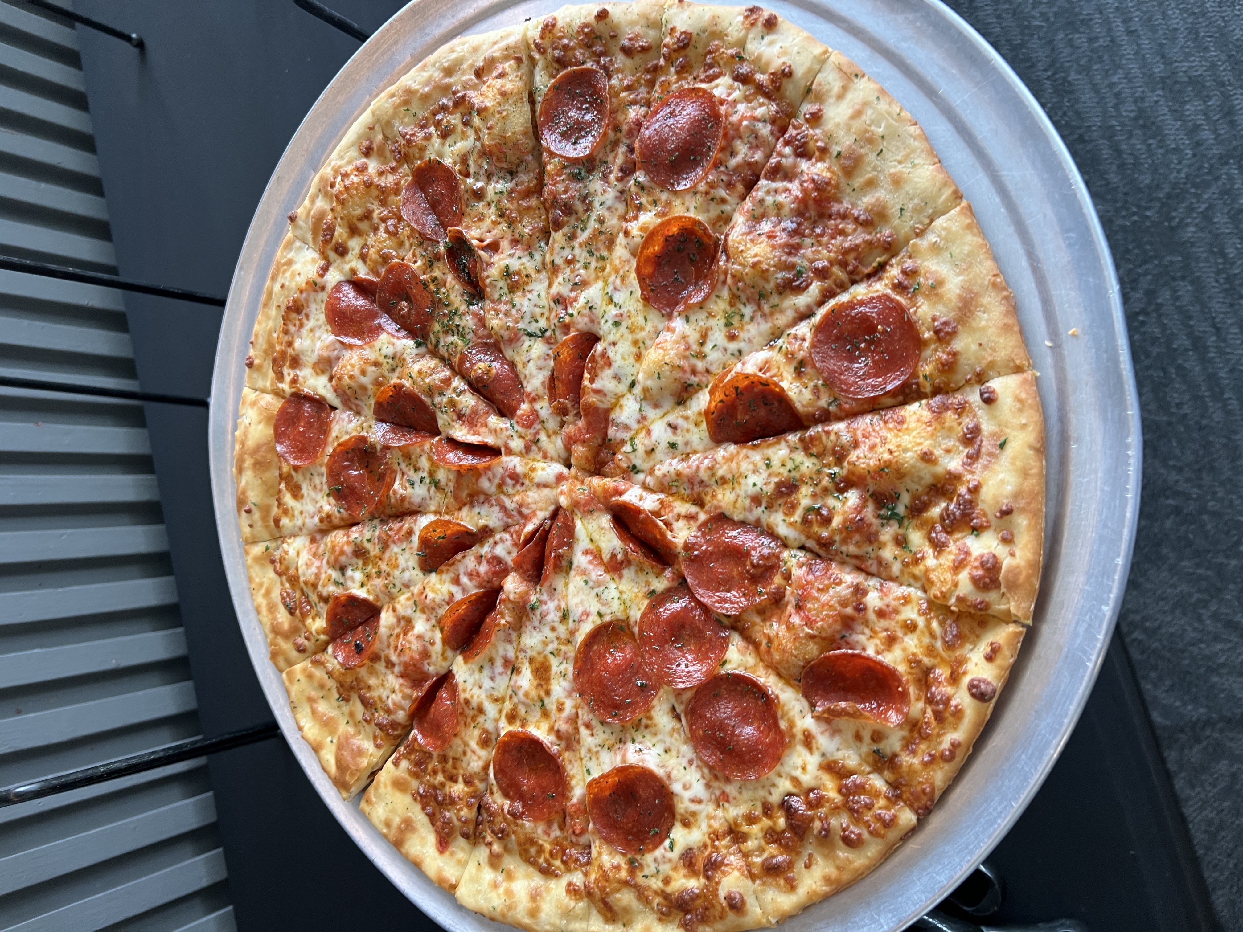 Southland's thin tavern-style pepperoni pizza on its serving tray