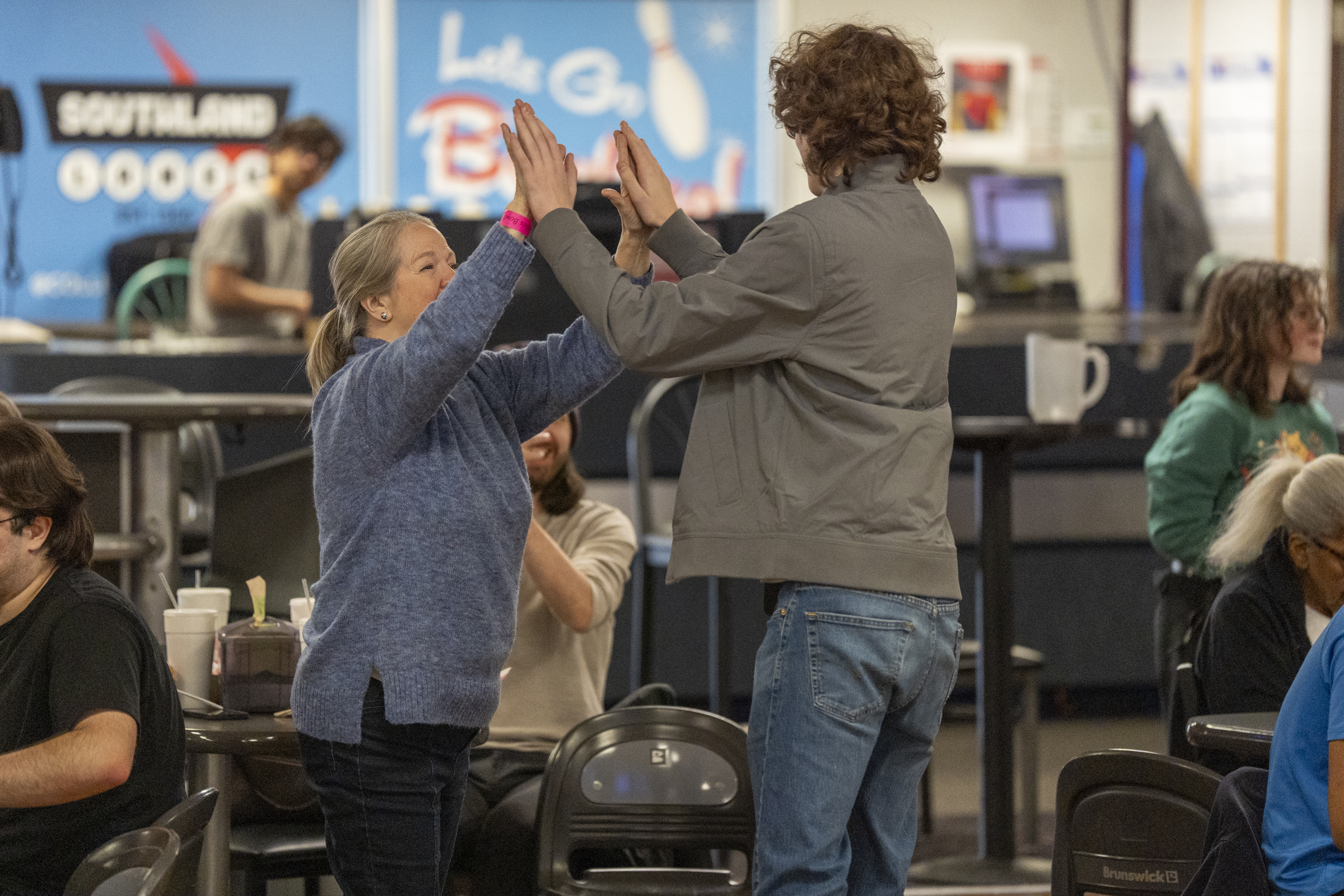 A social group of younger adults gathering on the lanes at Southland