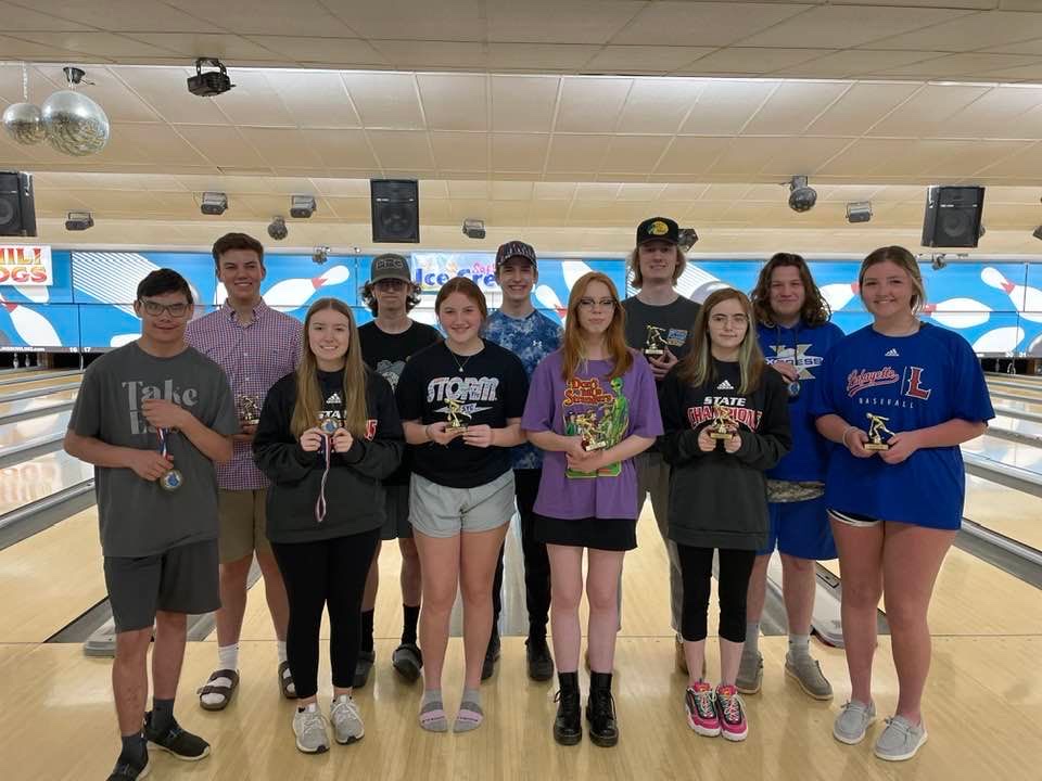 Southland youth league bowlers holding awards in front of the lanes